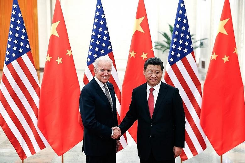 A CALL FOR BETTER CHINA-U.S. TIES President Xi Jinping and President Joe Biden when they met in 2013 in Beijing during Mr Biden's time as vice-president. In yesterday's phone call, the two leaders exchanged views on countering the pandemic and other 