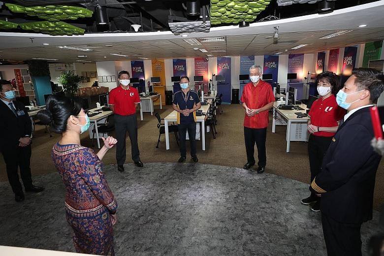 Prime Minister Lee Hsien Loong meeting Singapore Airlines cabin crew, pilots and support staff at the SIA Cabin Crew Control Centre at Changi Airport Terminal 3 on Friday. With him are (from left) NTUC secretary-general Ng Chee Meng, SIA chief execut