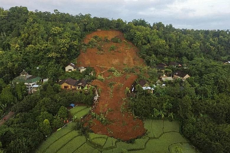 The aftermath of a landslide caused by torrential rain in Nganjuk, East Java, yesterday. Pasuruan, a town in the same province, was flooded after a river overflowed, forcing more than 350 people to flee their homes.