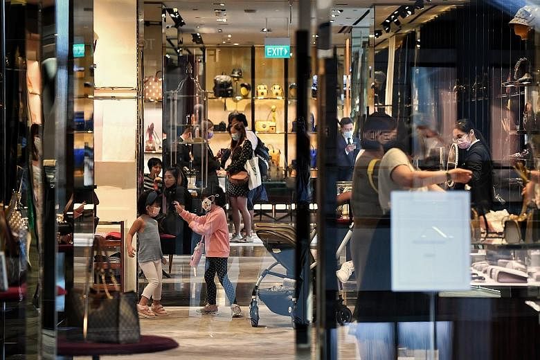 Shoppers at Marina Bay Sands yesterday. Deputy Prime Minister Heng Swee Keat said the GST hike will happen "sooner rather than later". ST PHOTO: KUA CHEE SIONG