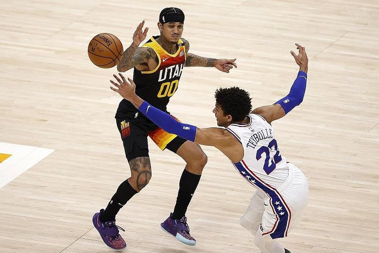 Jazz's Jordan Clarkson battling for the ball with the 76ers' Matisse Thybulle in the fourth quarter of their NBA game at Vivint Arena. The Jazz won 134-123 to improve to 23-5 - the league's best record.