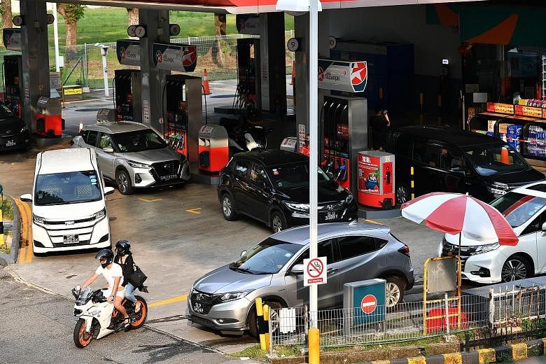 Motorists at a Caltex station in Beach Road yesterday. The petrol duty hike announced yesterday took immediate effect. ST PHOTO: LIM YAOHUI