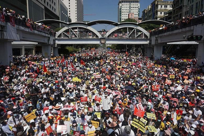 Protesters in Yangon blocking a major road during yesterday's rally against the military coup. Tens of thousands also took to the streets in Mandalay - the second-largest city in Myanmar after Yangon - where some people blocked its main rail link, an