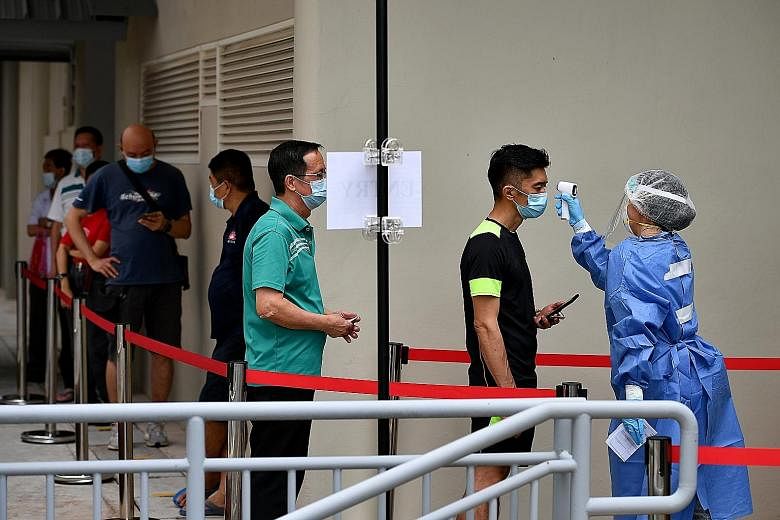 People queueing for a swab test outside Kreta Ayer People's Theatre in Chinatown on Feb 8. The number of new Covid-19 cases in the community increased from four cases two weeks ago to six in the past week.
