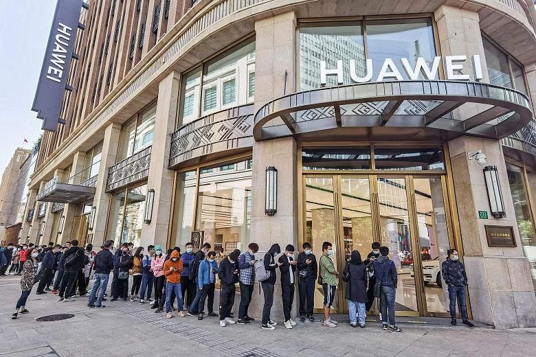 The queue at Huawei's store in Shanghai last October for the Mate 40 phone series. Chip shortages this year could affect the supply of gadgets.