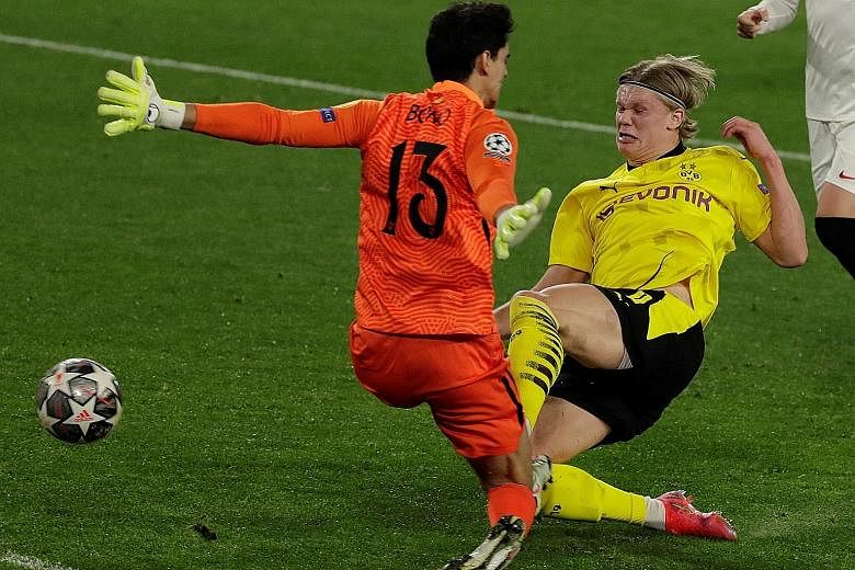 Erling Haaland scoring past Bono to give Dortmund the lead against Sevilla. His double has boosted his tally to 18 goals in 13 Champions League matches.