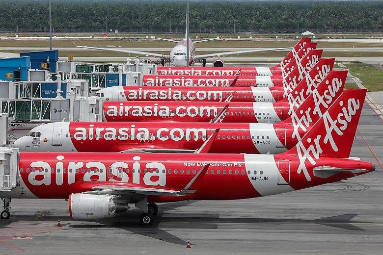 AirAsia planes parked at Kuala Lumpur airport last April, amid the Covid-19 pandemic's disruptions to air travel. Last July, the airline's auditors filed a report with Malaysia's stock exchange saying that the budget carrier may not survive. It has b