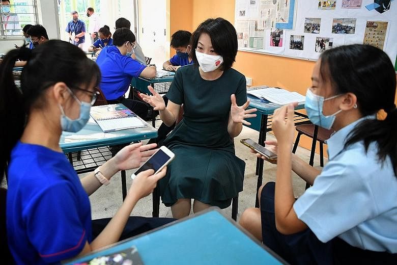 Minister of State for Education Sun Xueling chatting with Secondary 2 students Jennifer Tang (far left) and Kate Lau during a character and citizenship education lesson on mental health yesterday at Serangoon Secondary School. During the lesson, the 