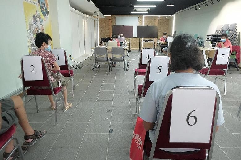 Residents waiting to book time slots for their Covid-19 vaccinations at Tanjong Pagar Community Club on Jan 26. Health Minister Gan Kim Yong said on Tuesday that measures are in place to give all Singaporeans, including those from lower socio-economi