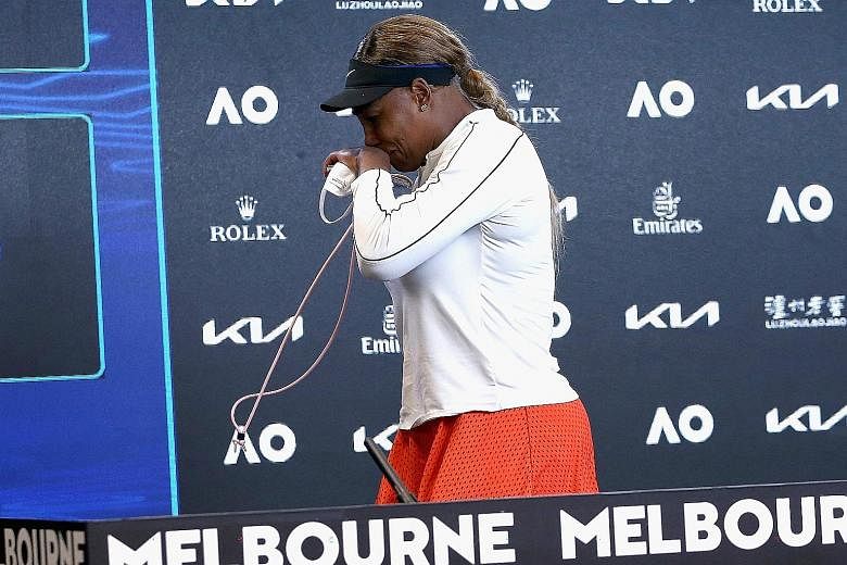 Naomi Osaka stretching for a return against Serena Williams (right, leaving the press conference in tears) in their Australian Open semi-final. Her aggressive moves had all the hallmarks of the former No. 1's play and she will be hot favourite in the