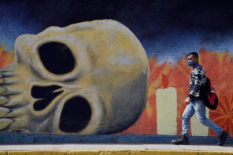 A mural on one of the walls at Mexico City's San Nicolas Tolentino cemetery. Mexico has suffered more than 150,000 deaths from Covid-19. In contrast, Japan, a country with a nearly identical population, has recorded just over 5,000 fatalities. In res