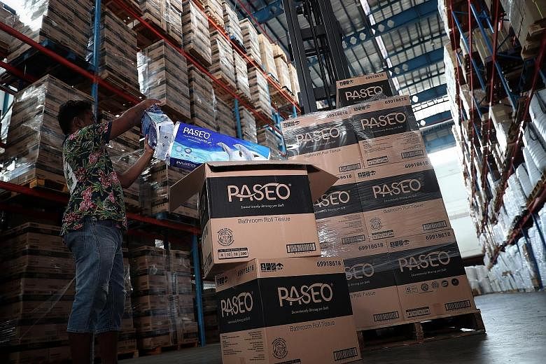 A stock keeper checking toilet paper rolls set for delivery at a warehouse last April. At the height of the pandemic, Singapore sprang into action to keep its supply chains open and its trade flows moving.