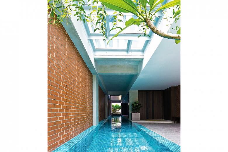 (Left) A lap pool was a priority for architects Tan Chee Yong and Rebecca Chia when they designed and built their home. (Above) Rooms open to the air well, with slide-and-fold walls for privacy. (Below) A 3m-long suar wood table is the centrepiece of