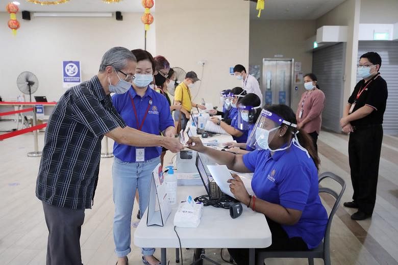 Above and left: People turning up to receive their Covid-19 vaccination jabs at the Jalan Besar Community Club yesterday. Having more than one approved vaccine provides the country some sort of insurance as Singapore will not need to rely on a single