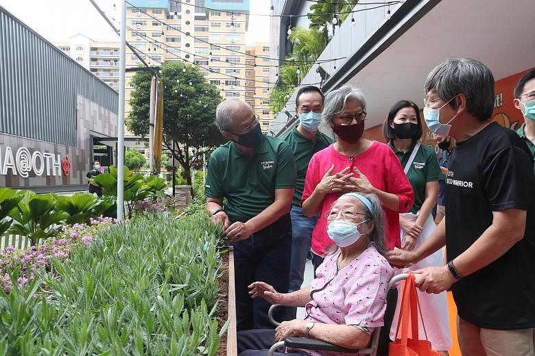Above: Minister for Social and Family Development Masagos Zulkifli (left) exploring Our Therapeutic Garden with grassroots leaders and residents yesterday. Right: The linear garden at Our Tampines Hub is part of efforts to transform the Tampines esta