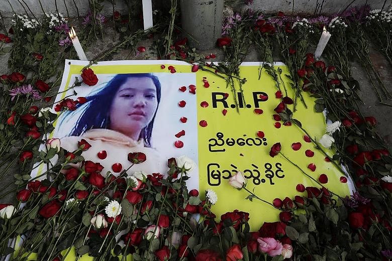 Flowers and candles placed at a memorial for Ms Mya Thwate Thwate Kaing, who died after being wounded by live rounds during an anti-coup protest. She is the first confirmed fatality in the demonstrations in Myanmar.