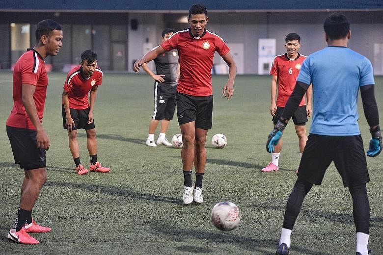 Khairul Nizam (centre) training with Geylang teammates at Our Tampines Hub last November. The forward has since joined SPL rivals Hougang but is still waiting to make his Cheetahs debut owing to the pandemic.