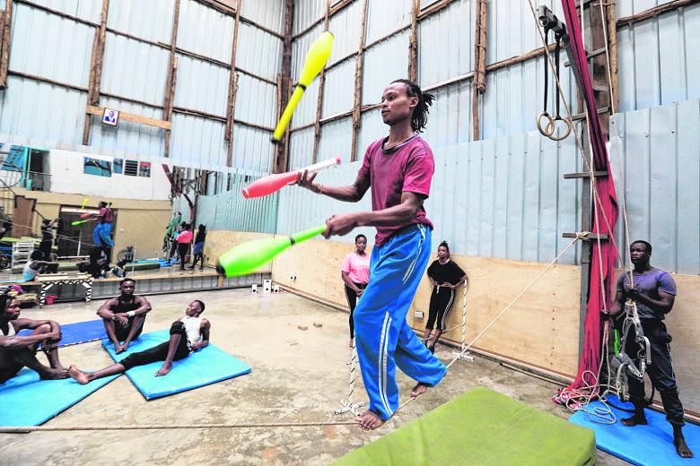 UPLIFTING SPIRITS:(Above, far left and left) Kenyan acrobatic members of the Mighty Jambo Circus Academy during their training routine at the school in Nairobi, Kenya. The academy has resumed its daily exercise regimen after months of closure since t