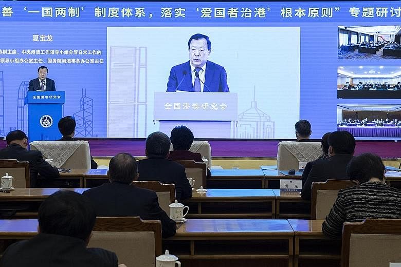 Hong Kong and Macau Affairs Office director Xia Baolong addressing a forum in Beijing yesterday. Mr Xia said Hong Kong's electoral system must be improved under the leadership of the central government.