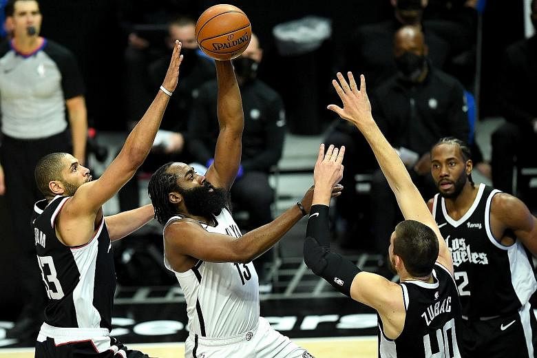 Nets guard James Harden driving to the basket amid the attentions of the Clippers' Nicolas Batum and Ivica Zubac. Harden led Brooklyn to a fifth straight win on the road, underlining their status as one of the East's leading teams.