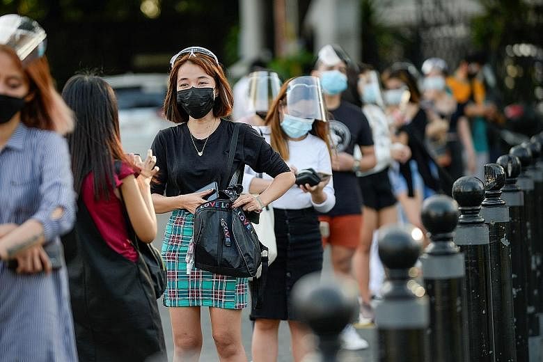 People wearing face masks and face shields in Manila, amid the coronavirus outbreak, last Thursday. A task force overseeing the Philippine government's Covid-19 efforts had advised President Rodrigo Duterte to further ease quarantine curbs to revive 