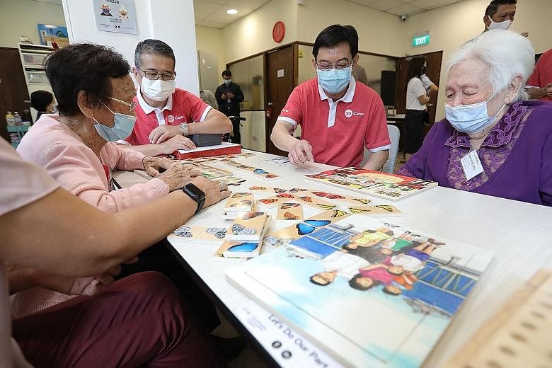 Deputy Prime Minister Heng Swee Keat, Minister for Culture, Community and Youth Edwin Tong and CareLibrary participants Oon Siew Eng (right), 87, and Phua Ai Lien, 92, at the SG Cares Volunteer Centre @ Geylang yesterday. CareLibrary is a programme t