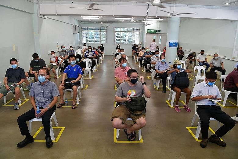 Taxi and private-hire car drivers resting after receiving their first dose of the Covid-19 vaccine at the vaccination centre in the former Hong Kah Secondary School yesterday. While Senior Minister of State for Transport Amy Khor noted that some had 