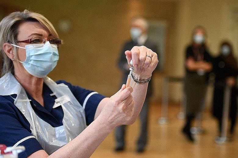 A nurse preparing a dose of the AstraZeneca vaccine at a vaccination centre in Nottingham, England. No other large country is inoculating people as quickly as Britain, which was the first country in the world to authorise and begin using both the Pfi