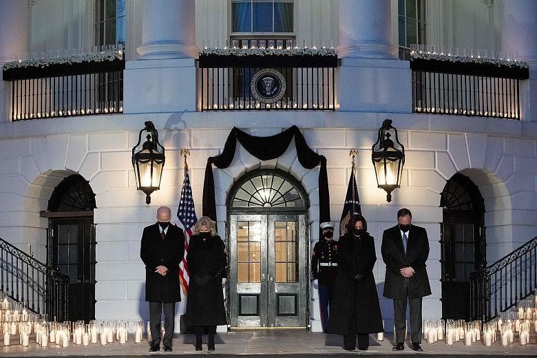 US President Joe Biden and First Lady Jill Biden, along with Vice-President Kamala Harris and her husband Doug Emhoff, observing a moment of silence during a candlelight ceremony at the White House on Monday in honour of those who lost their lives to