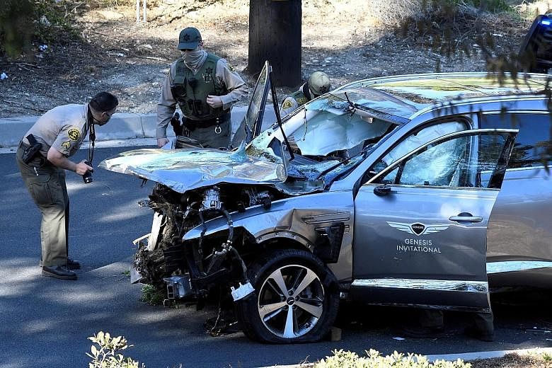 Above: Los Angeles County sheriff's deputies inspect the SUV of golfer Tiger Woods, who was involved in a single-vehicle accident near Los Angeles on Tuesday. Left: Woods' damaged car after rolling down the hillside.