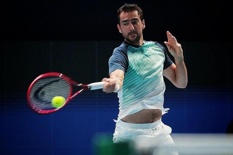 Ex-world No. 3 Marin Cilic returning to Taro Daniel in their last-16 match at the Singapore Tennis Open yesterday. He overcame early hiccups to win in straight sets.