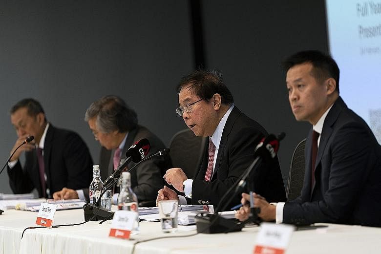 Though OCBC Bank's fourth-quarter net profit was down 9 per cent from $1.24 billion in 2019, it was ahead of the $968 million average estimate of seven analysts polled by Bloomberg. Chief executive Samuel Tsien (below, third from left) says OCBC beli