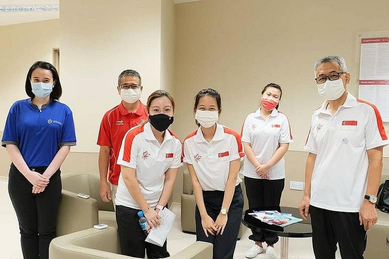 (From left) NCID senior staff nurse Alicia Chua, Minister for Culture, Community and Youth Edwin Tong, Team Singapore shooters Adele Tan, Tessa Neo and Ho Xiu Yi, and their coach Song Haiping at the centre on Wednesday.