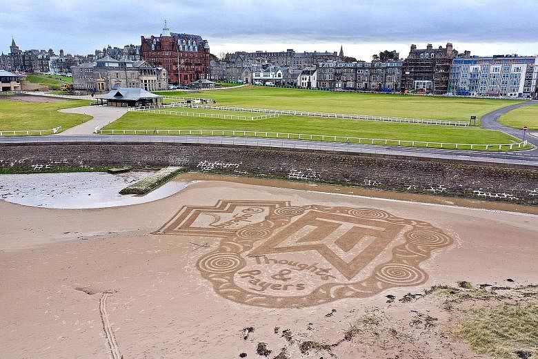 A sand art message in support of Tiger Woods is seen on the beach of St Andrews in Scotland.