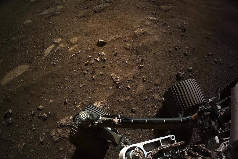 A photo released by US space agency Nasa, taken by the Perseverance rover, of the ground at Mars' Jezero Crater, on Sunday. Nasa said Perseverance's cameras will help scientists assess the geologic history and atmospheric conditions of the crater, an