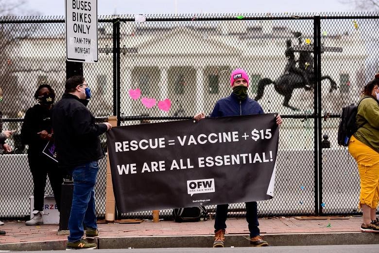 Protesters demanding a federal minimum wage of US$15 (S$20) per hour near the White House on Friday. The Biden coronavirus relief plan has been passed in the US House, but Democrats face challenges to their hopes of using the Bill to raise the minimu