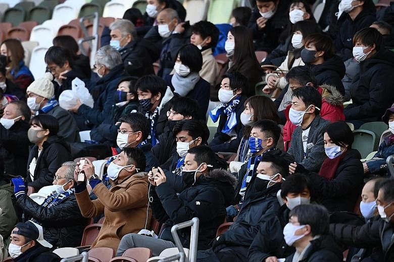 Masked fans watching the Emperor's Cup football final at the National Stadium in Tokyo on Jan 1. Scenes like this are likely at the Olympics if the go-ahead is given for live audiences.