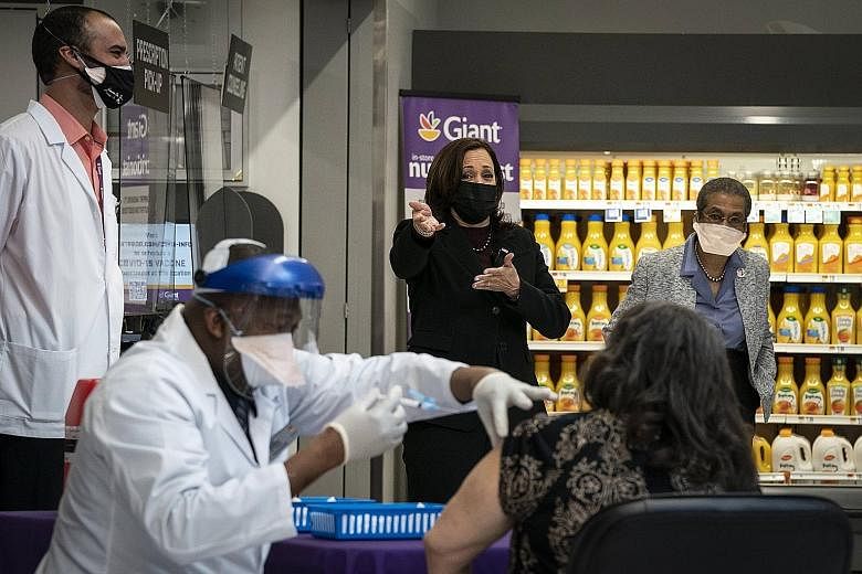 US Vice-President Kamala Harris watching as a doctor administers the Covid-19 vaccine in the pharmacy of a Giant Foods store in Washington last Thursday. The government started giving vaccines to pharmacies on Feb 11, sending one million doses a week