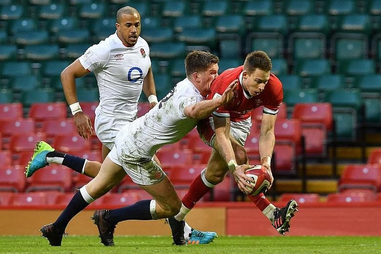 Wales full-back Liam Williams evading England centre Owen Farrell's tackle to score their second try in the Six Nations match. It was given despite a suspected knock-on.