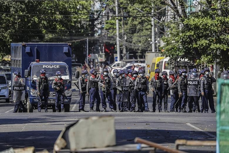 Anti-riot police officers securing the area after dispersing protesters in Yangon yesterday. Preventing further bloodshed requires Asean and other countries to call for both sides to exercise restraint: the protesters as well as the Tatmadaw, says th