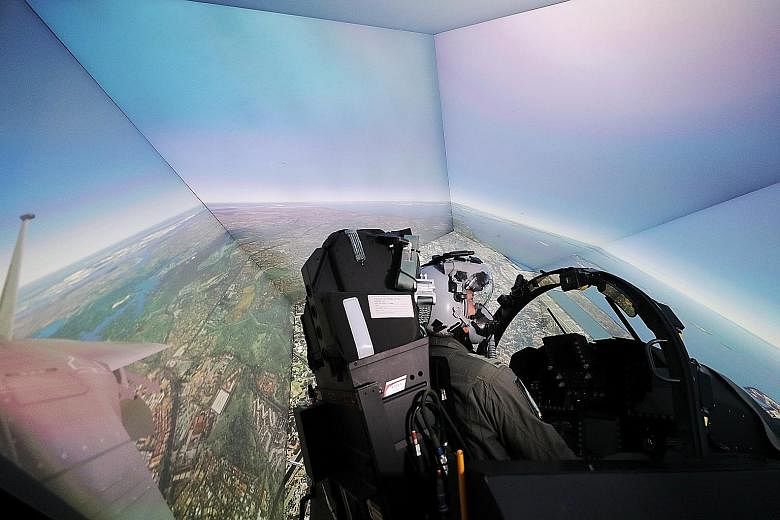 A pilot in the Republic of Singapore Air Force's F-15SG Air Mission Trainer at Paya Lebar Air Base. The simulator saves the RSAF about 14 per cent in costs for the training of fighter pilots and weapon systems officers, while significantly cutting tr