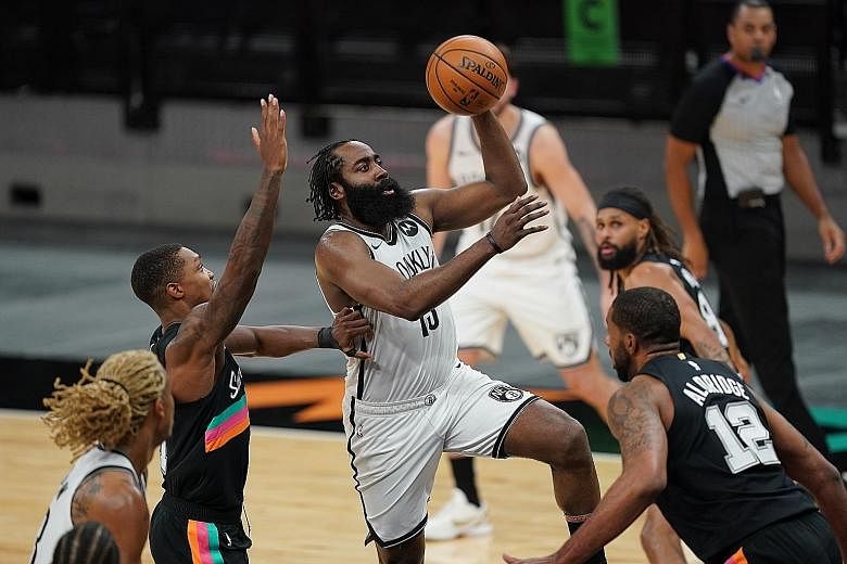 Brooklyn guard James Harden taking one of his 23 shots against San Antonio in their NBA game on Monday. He made 12 field goals to finish with a 30-point triple-double.