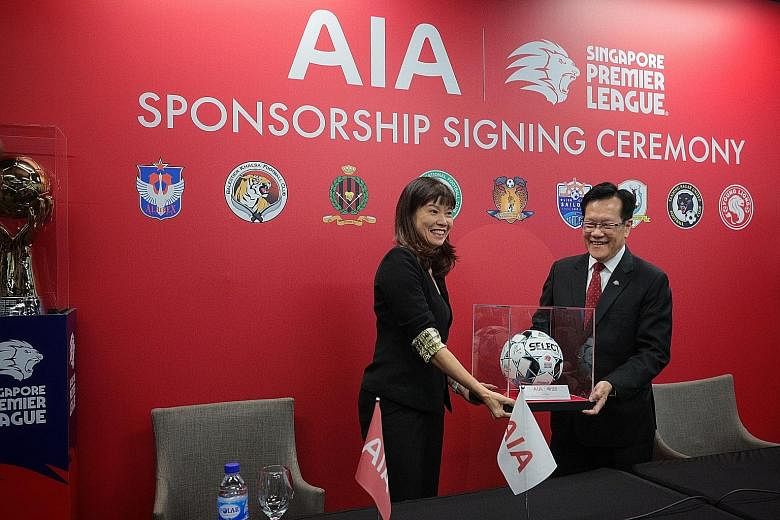 Left: Albirex celebrating last December after winning their fourth Singapore Premier League title. ST FILE PHOTO Below: FAS president Lim Kia Tong and AIA Singapore chief executive officer Wong Sze Keed at yesterday's sponsorship signing ceremony at 