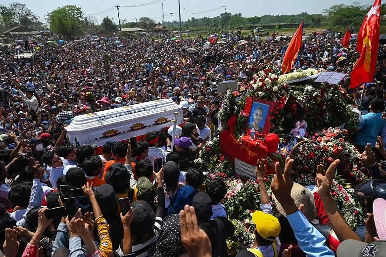 Mourners in Yangon yesterday surrounding the coffin of protester Nyi Nyi Aung Htet Naing, who died after being shot during a demonstration against the military coup in Myanmar. Mr Kaung Myat Hlaing, a reporter for the Democratic Voice of Burma news o