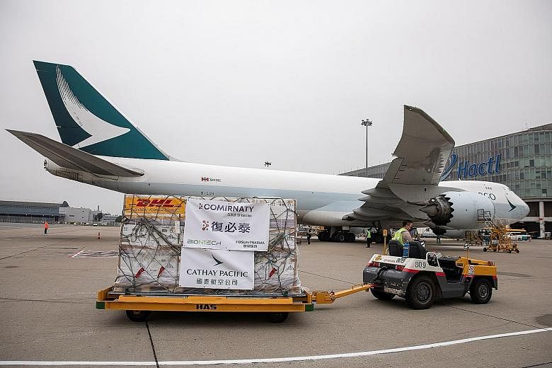 Covid-19 vaccines being transported to a warehouse after being unloaded from a Cathay Pacific cargo plane at Hong Kong International Airport last weekend. A significant rebound in global economic activity, including vaccine distribution, saw global a