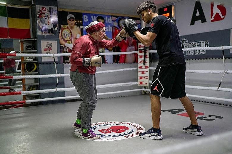 Ms Nancy Van Der Stracten, a 75-year-old who has Parkinson's disease, boxing with her trainer Muhammed Ali Kardas in the ring at a boxing club in Antalya, Turkey, last week. She discovered the benefits of non-contact boxing while researching the dise