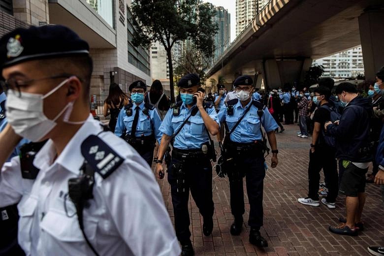 Hong Kong police arrest 12 over 'ramp and dump' stock scam | The ...