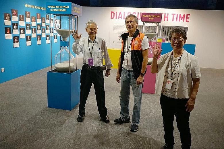 Mr Mike Goh (centre) with fellow senior guides at the Dialogue With Time - Embracing Ageing exhibition at the Science Centre Singapore.