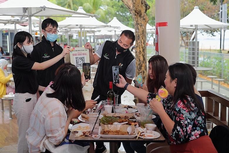 Minister of State in the Prime Minister's Office and for National Development Tan Kiat How, chairman of government feedback arm Reach, getting diners at East Coast Lagoon Food Village to give their views on Singapore women's development via an online