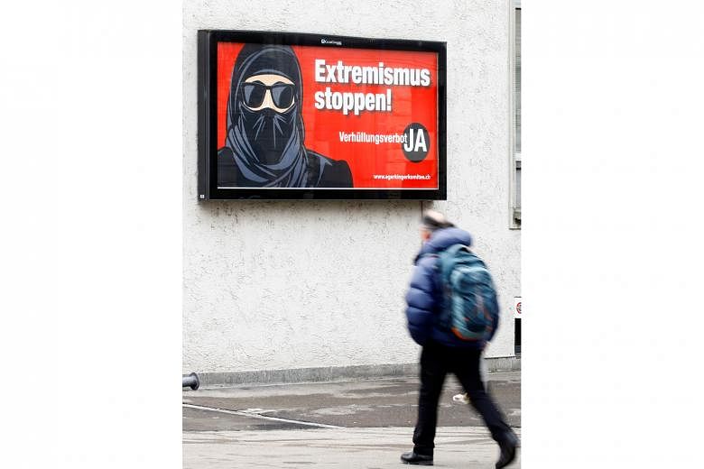 A poster against wearing the burqa seen in Zurich. It reads: "Stop extremism! Veil ban - Yes". The far-right proposal to ban facial coverings in Switzerland won a narrow victory in a binding referendum on Sunday.